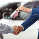 A sales representative and a customer shaking hands.