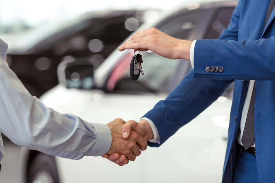 A sales representative and a customer shaking hands.